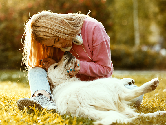 dog with lady owner in meadow